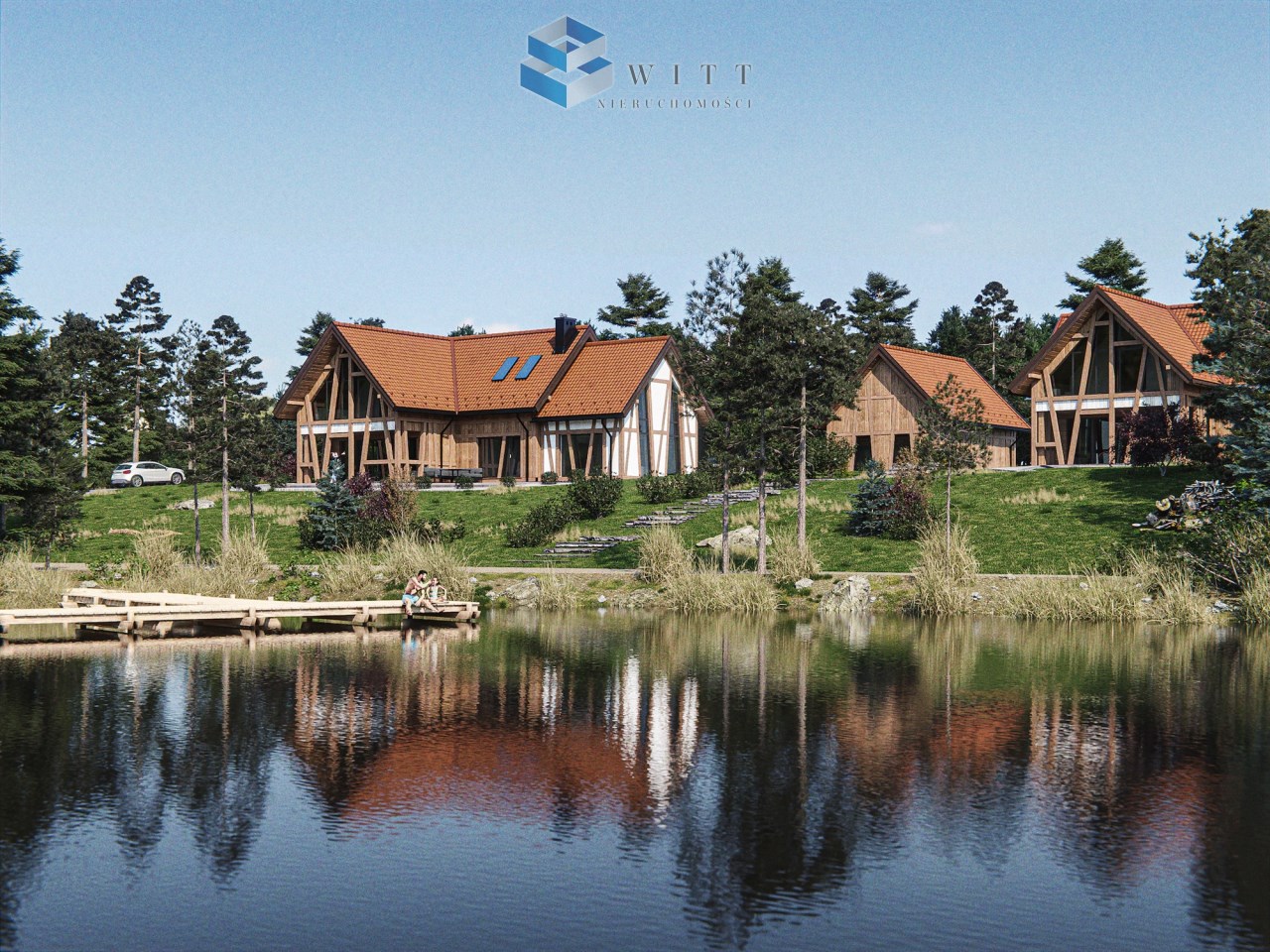 Widok na nowoczesne domy w stylu skandynawskim nad jeziorem, otoczone zielenią i drzewami. W tle widać drewniany pomost oraz rodziny spędzające czas nad wodą.