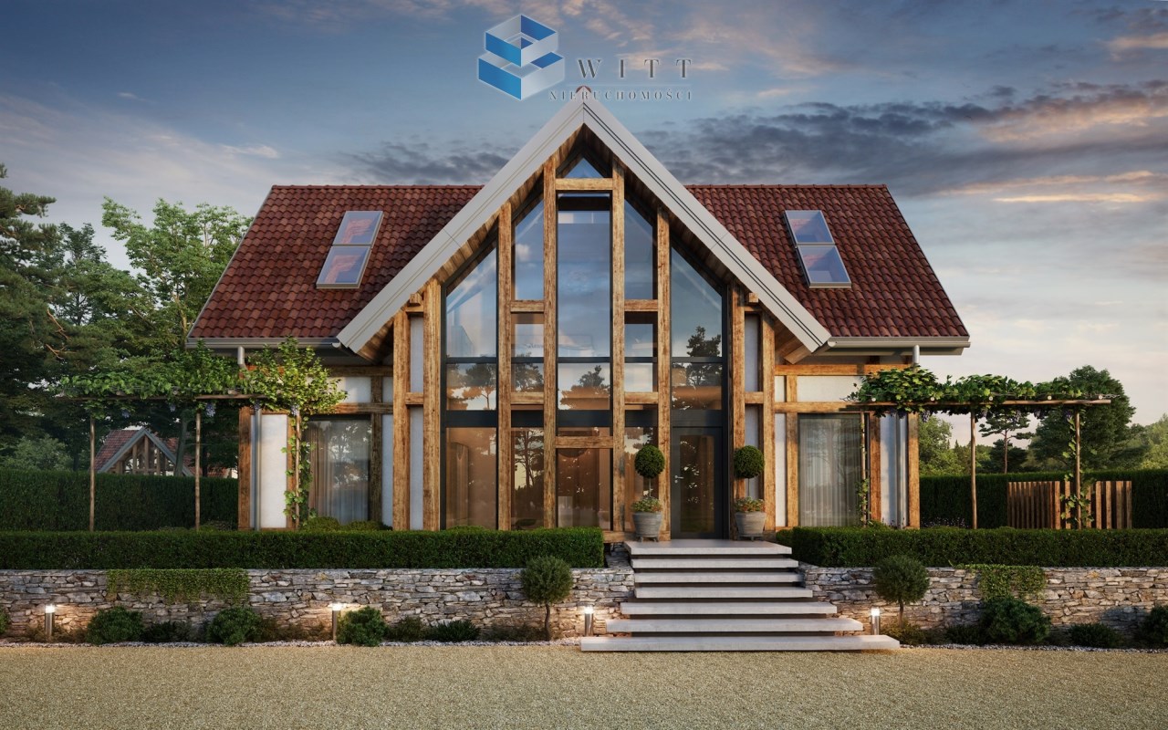 Nowoczesny dom jednorodzinny z dużymi oknami, drewnianymi elementami i czerwonym dachem, otoczony zielenią i starannie utrzymanym ogrodem. W tle widoczna jest spokojna okolica. Logo WITT Nieruchomości w górnym lewym rogu.
